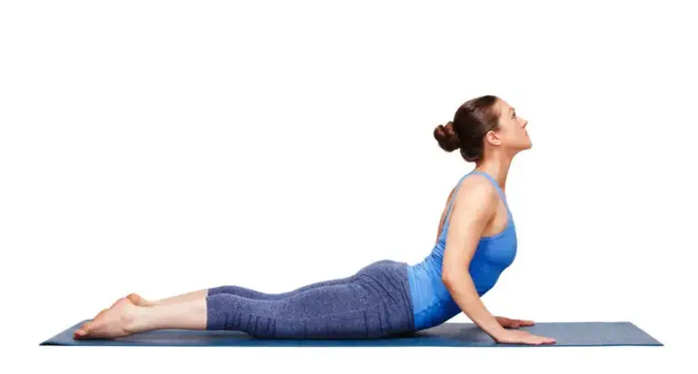 Person performing a bird-dog core exercise on a mat to support posture in flat back syndrome