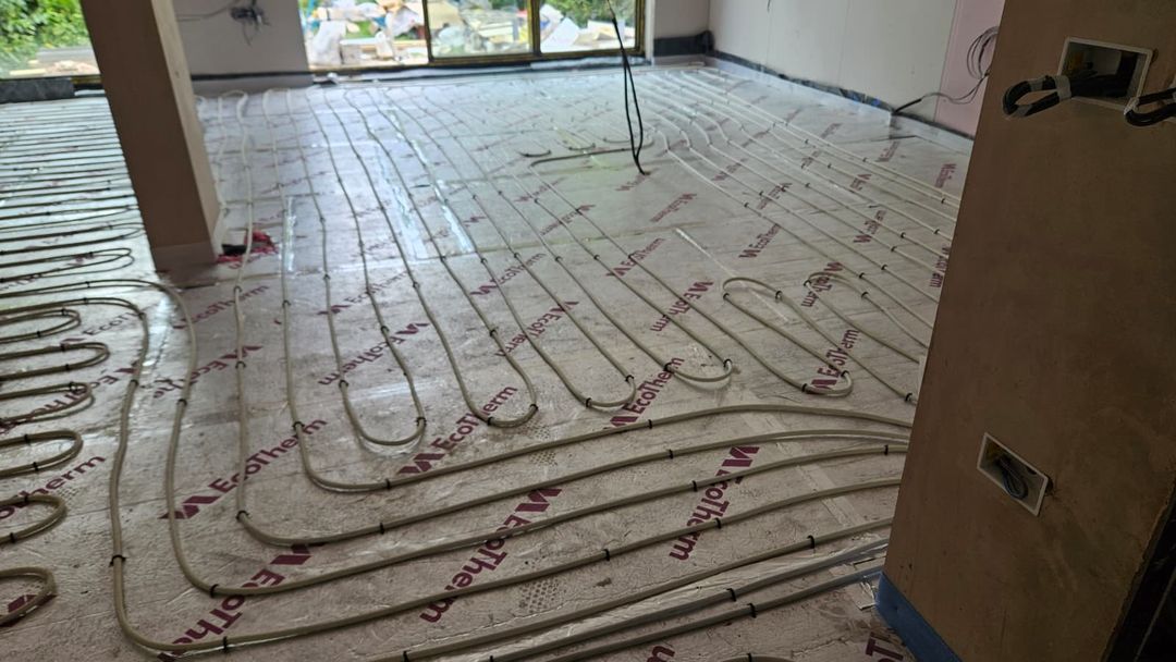 Underfloor heating installation showing concealed renovation work and costs