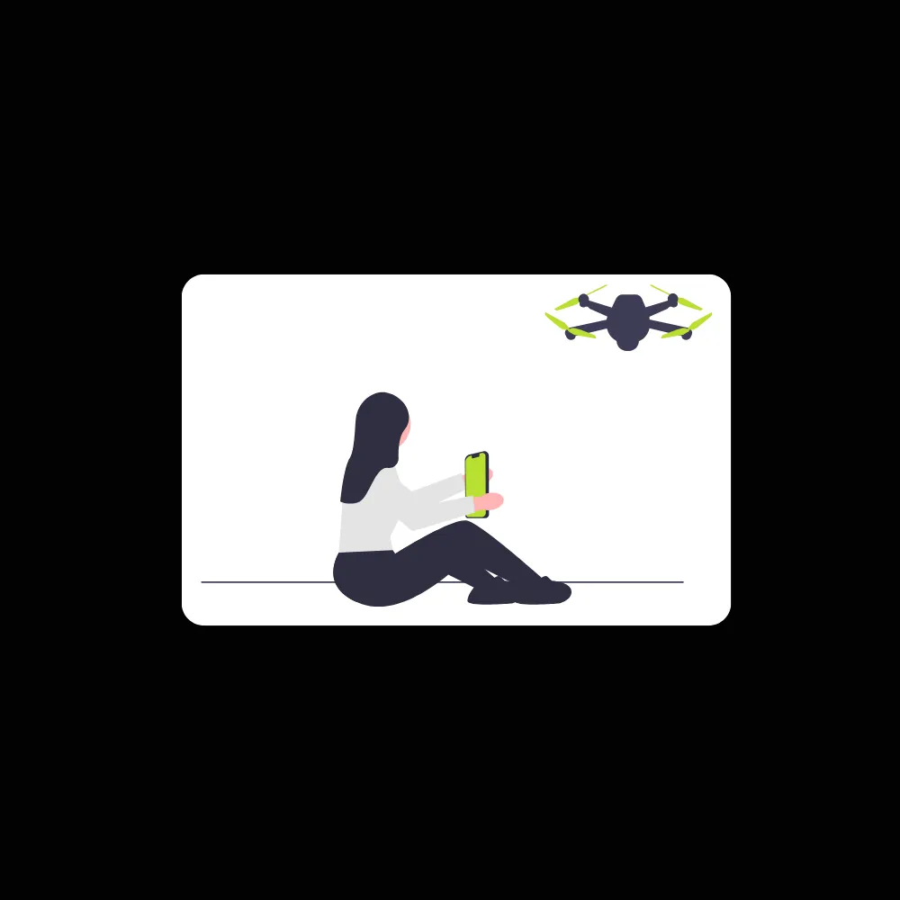 Person sitting on the ground holding a smartphone and controlling a flying drone.