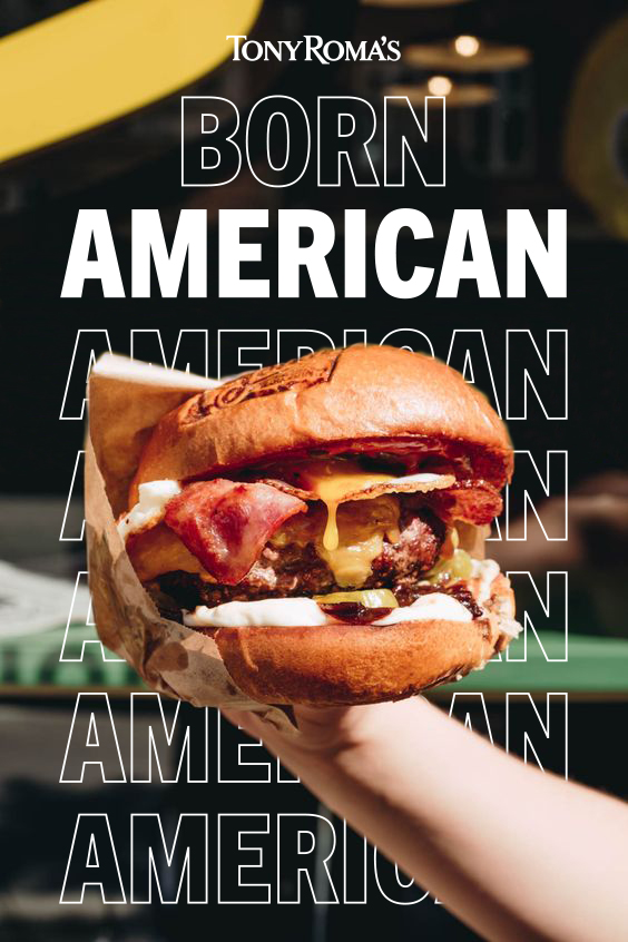 Hand holding a bacon cheeseburger with melted cheese, lettuce, and sauce in a toasted bun, with Tony Roma's logo and text 'Born American' in the background.