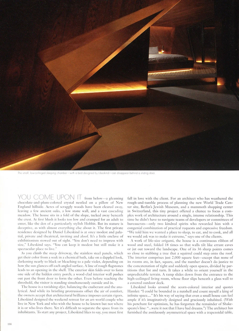Magazine article page featuring a CNR Group NYC luxury home build interior: a dimly lit, angular modern bedroom with a low bed visible through a partially opened geometric wooden sliding door, accentuated by warm under-bed and floor lighting.