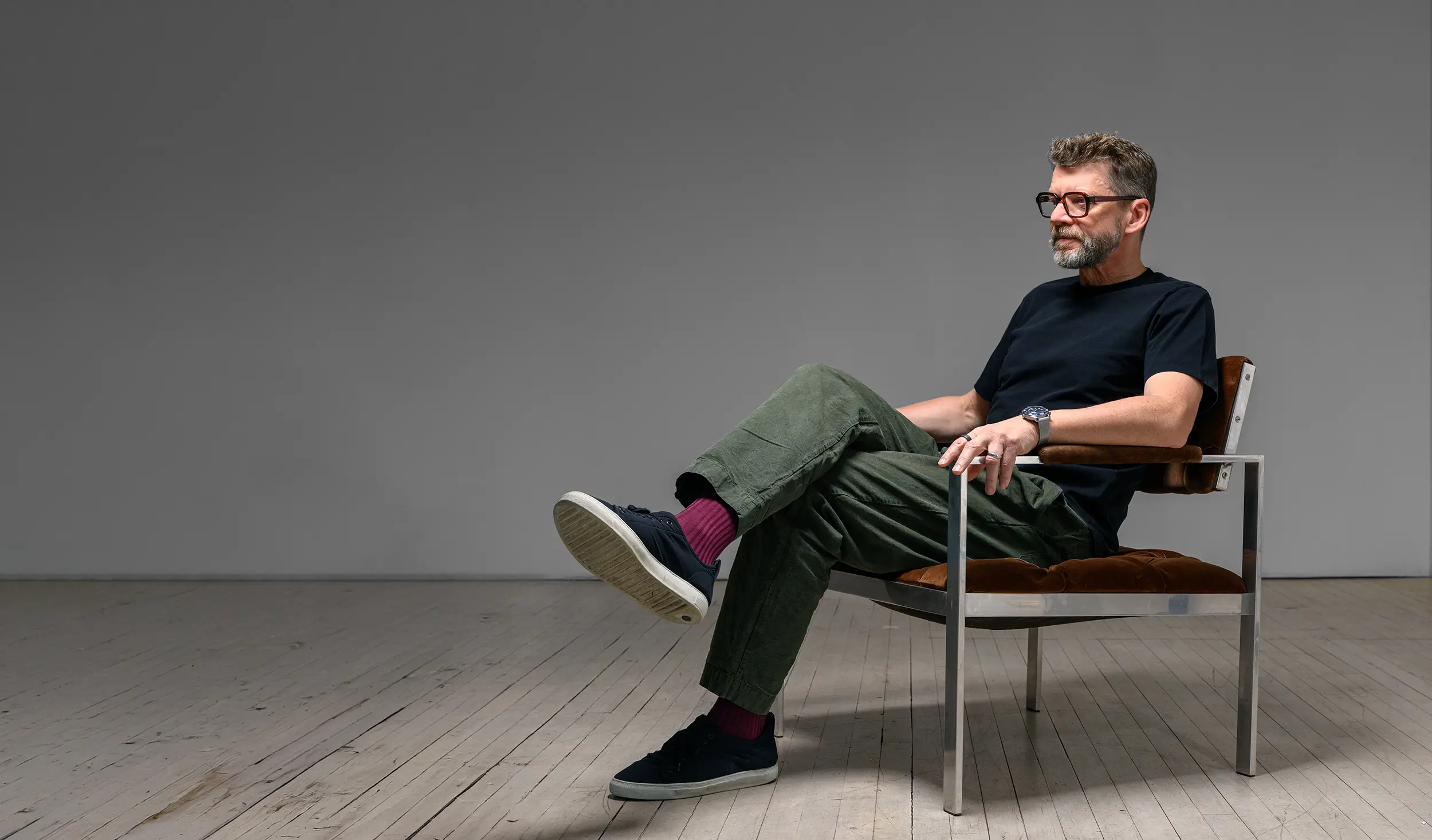 Founder of CNR, Jesse, sitting in a chair looking off to the side.