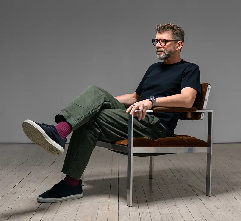 Founder of CNR, Jesse, sitting in a chair looking off to the side.