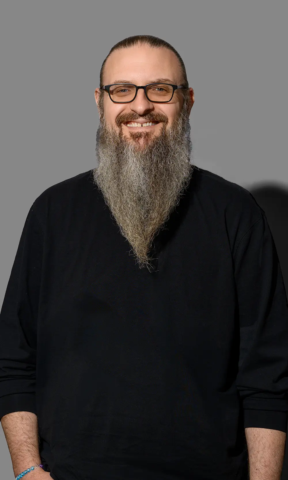 CNR Group luxury builders team member: Bradley. Smiling man with pointed beard wearing a black shirt.