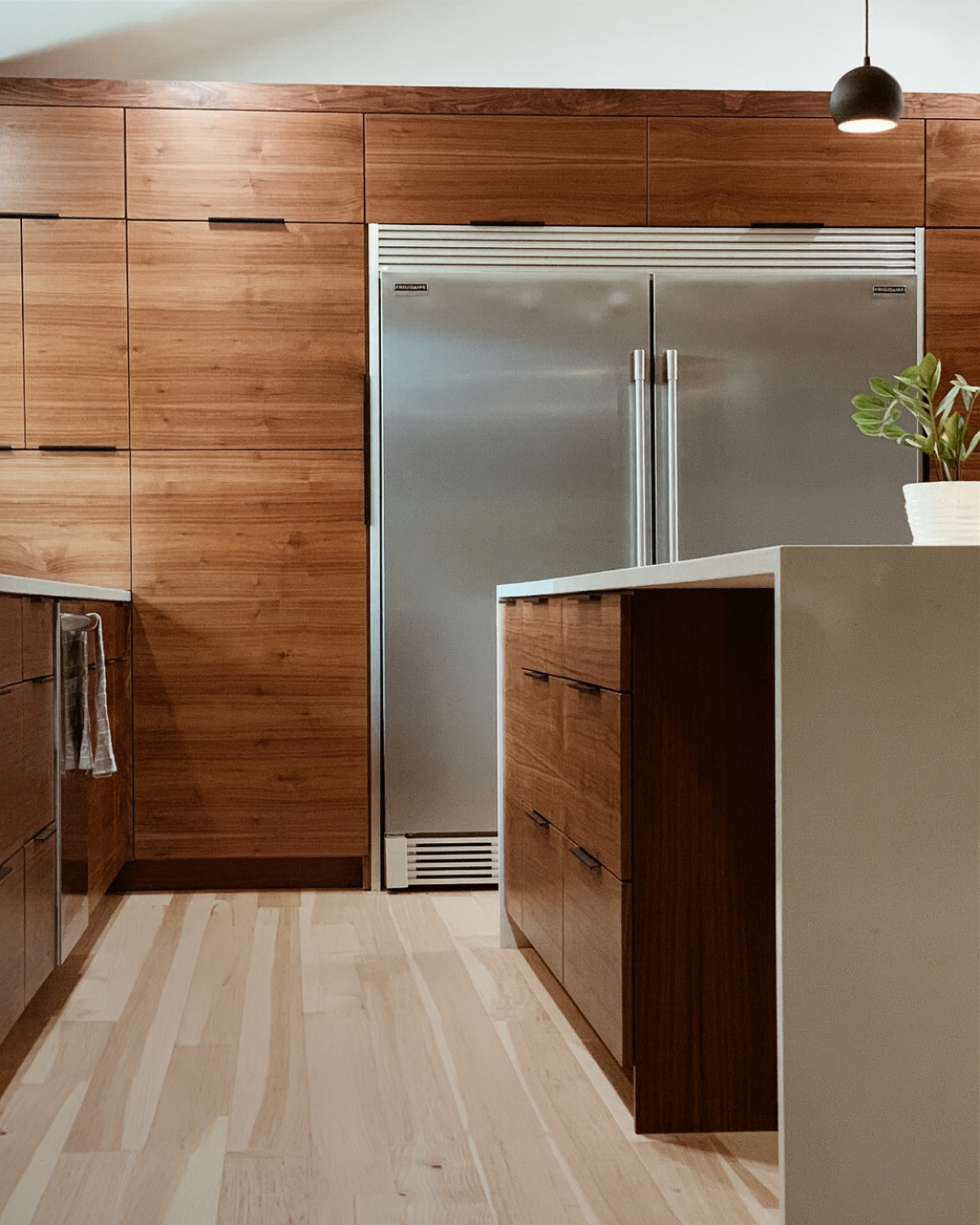 A photo of custom walnut cabinetry in a beautiful kitchen.