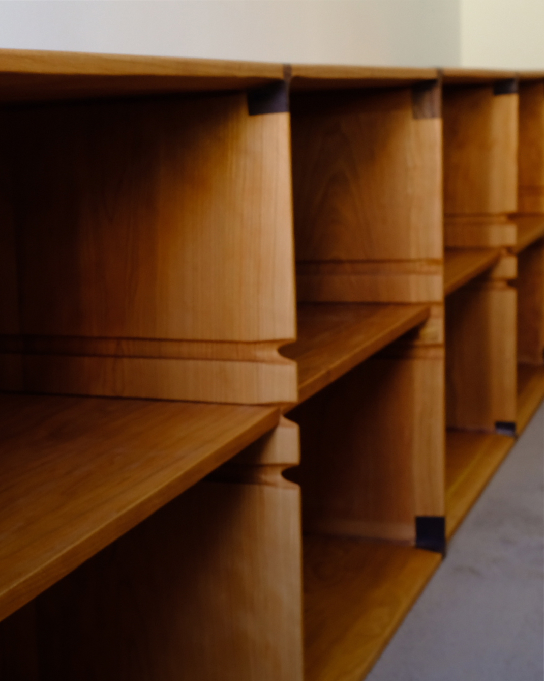 A photo of unique custom made bookshelves beautifully stained.