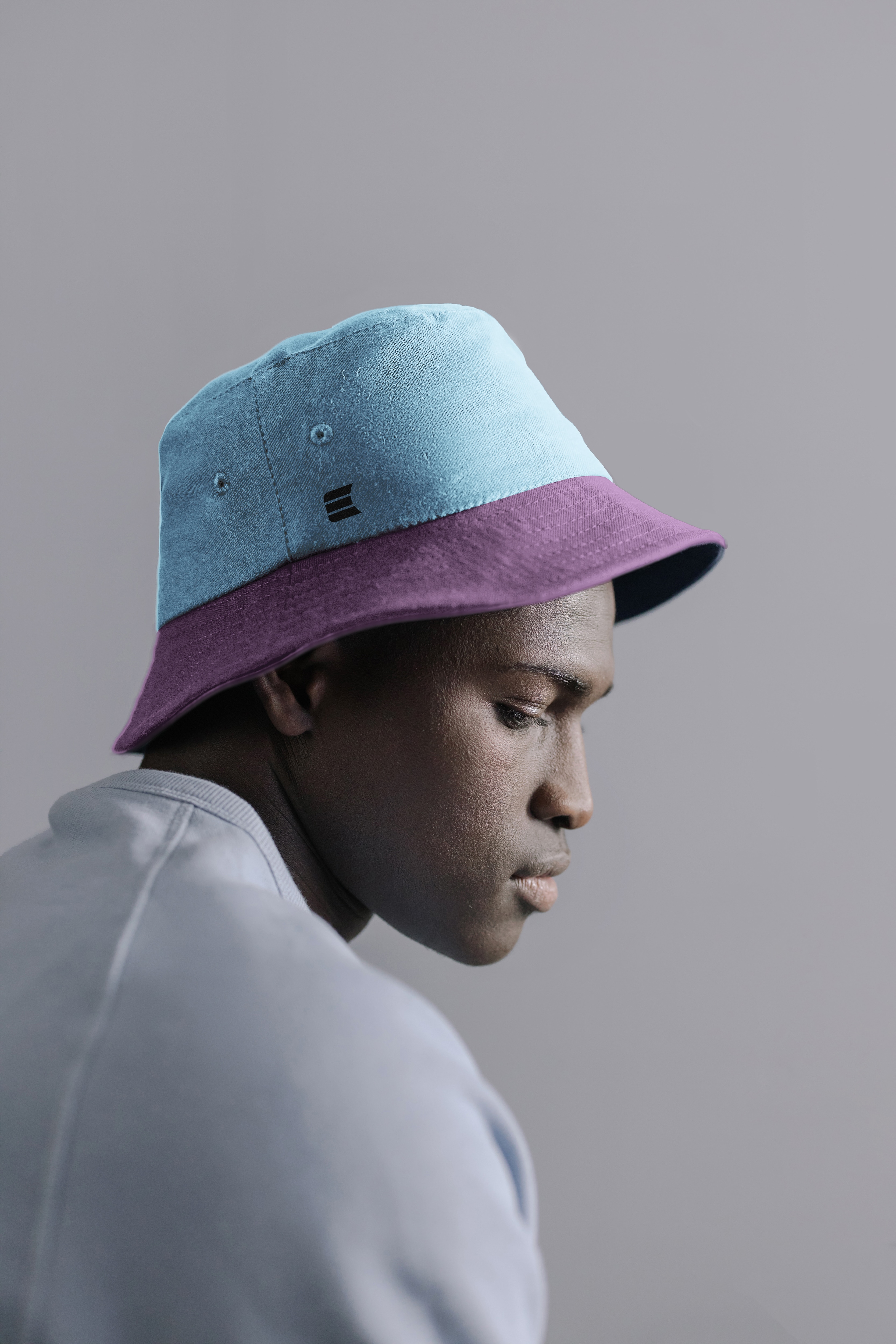 person with "E" logo bucket hat