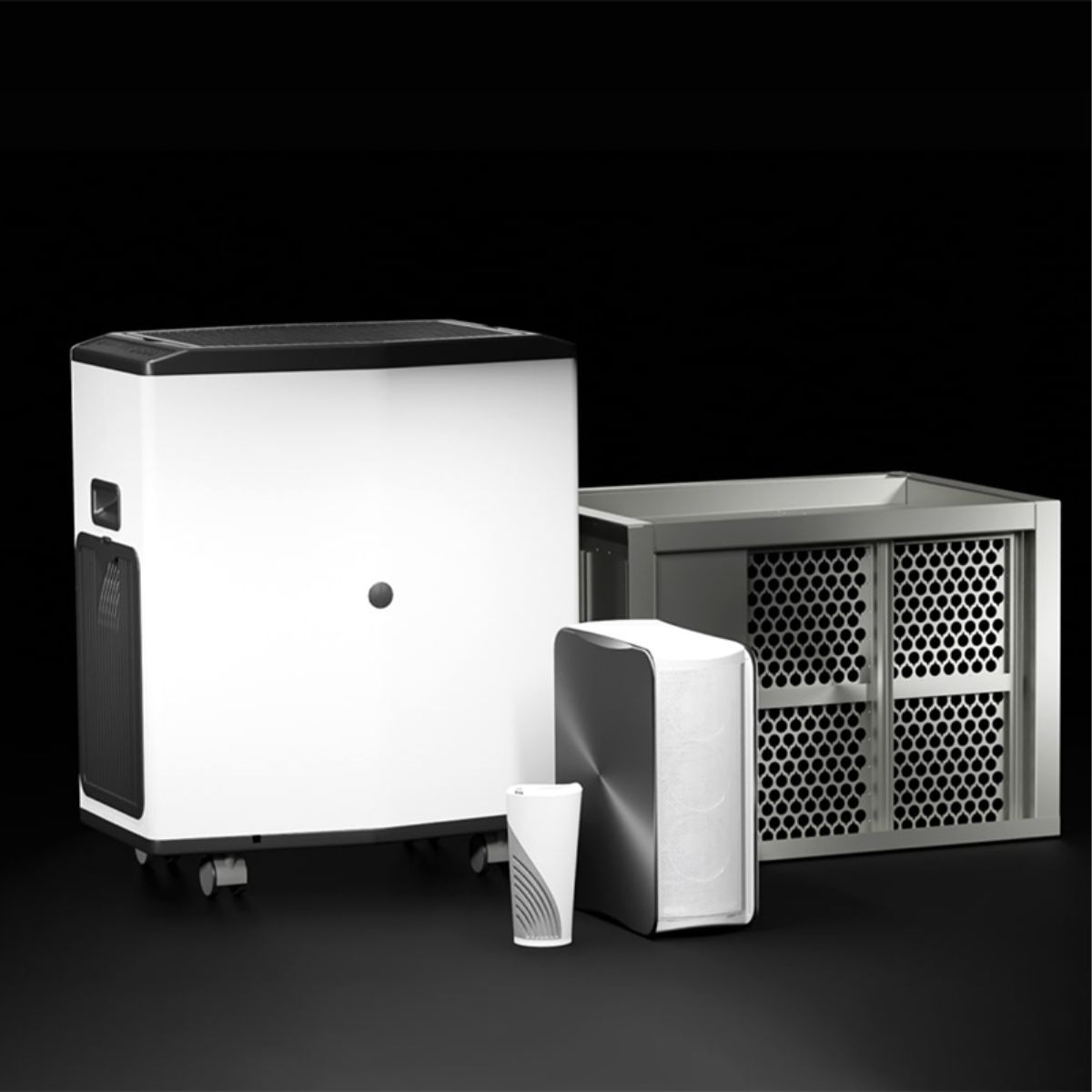 Four modern air purification devices of varying sizes with white and metallic finishes on a black background.