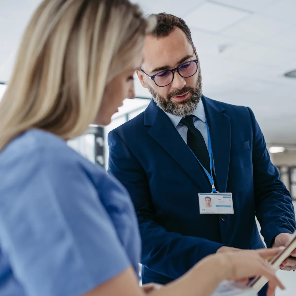 a business professional speaking to a doctor in a hospital setting.