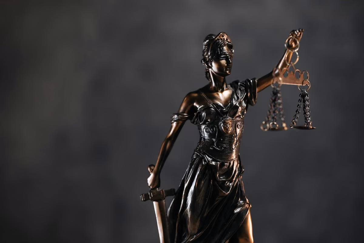 statue of justice, blindfolded holding scales.