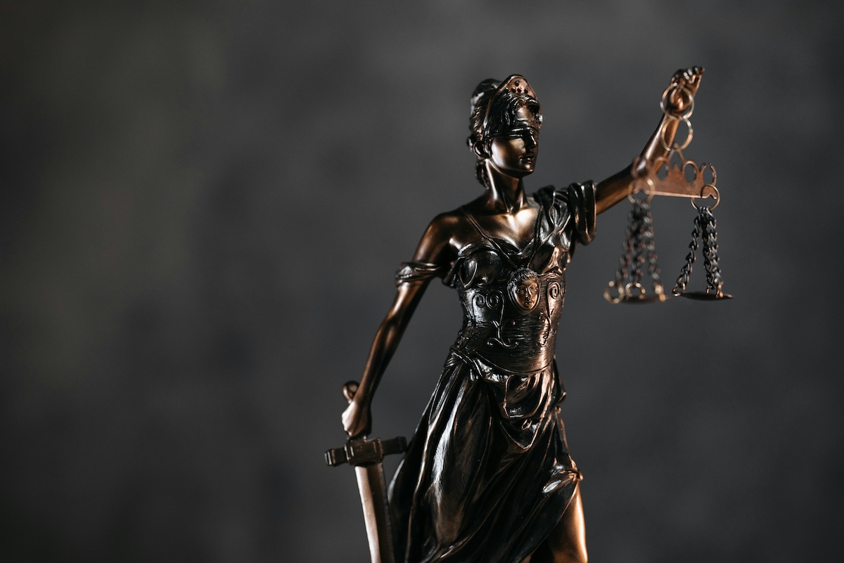 statue of justice, blindfolded holding scales.