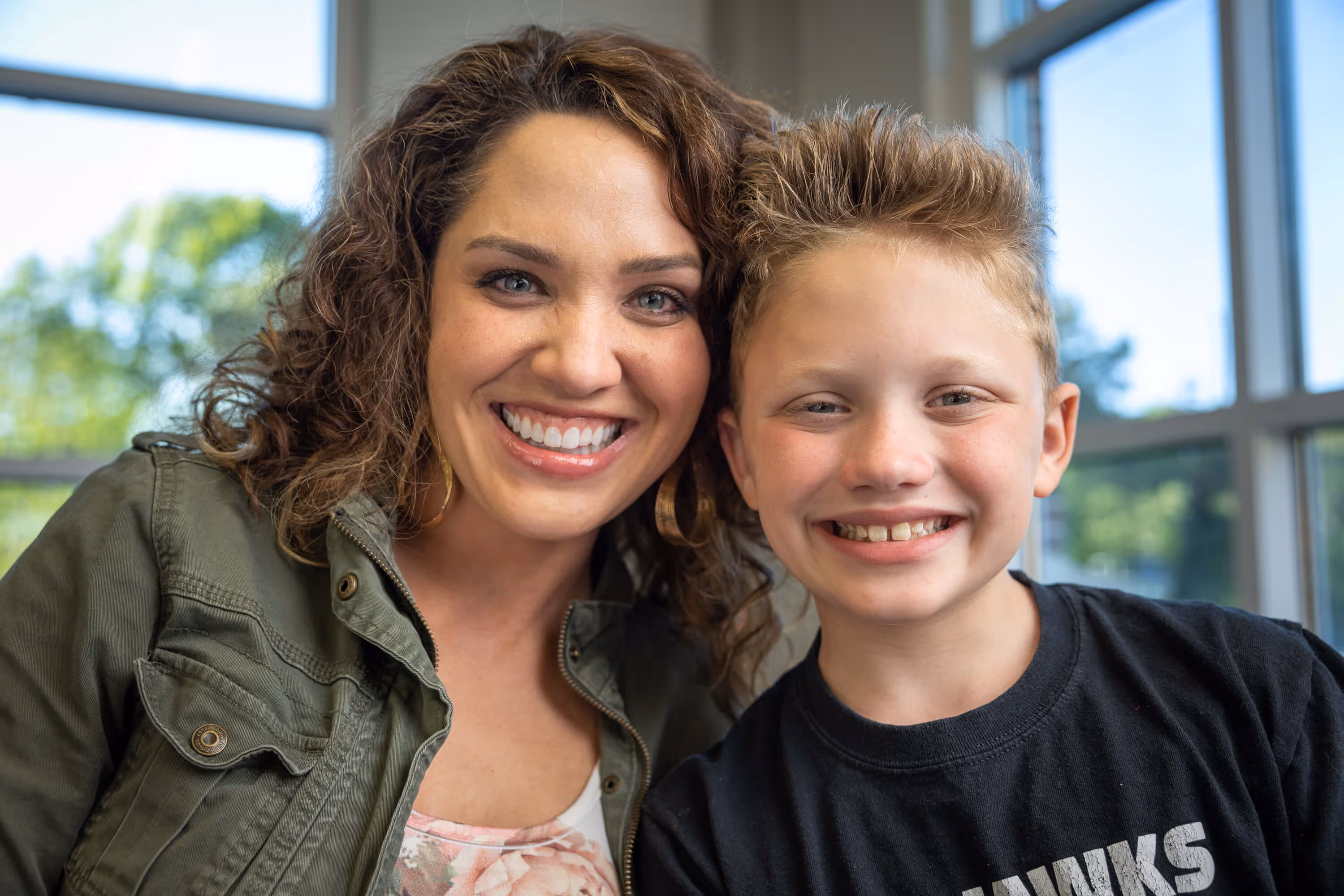 Titus, a young athlete with a disability, is with his mother Victoria