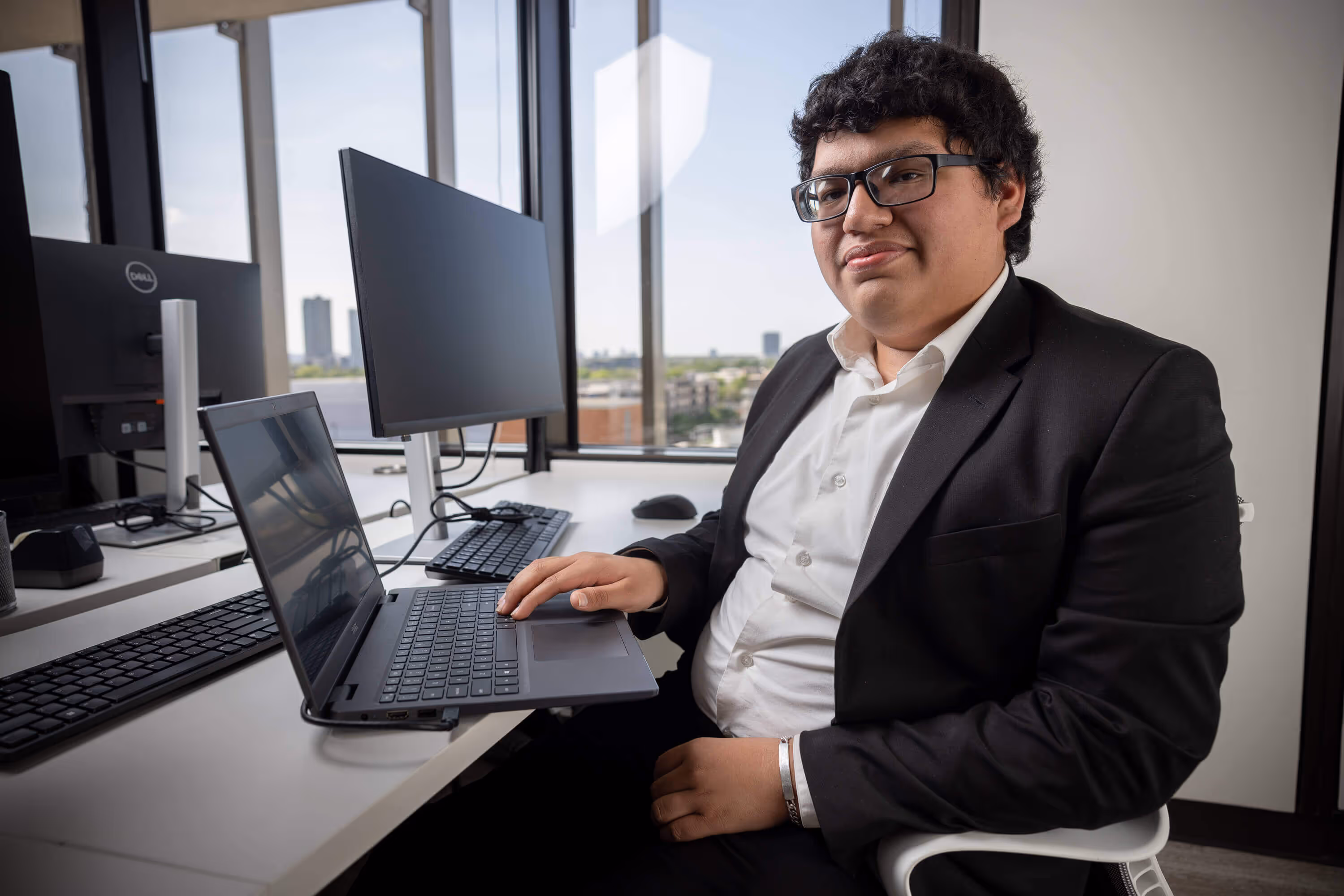 Geraldo is a student intern shown at his desk using a computer