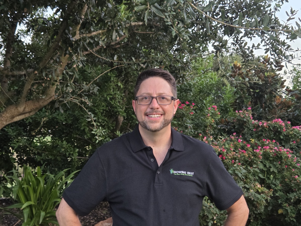 EJ McCoy of Mowing Best standing in a North Texas garden