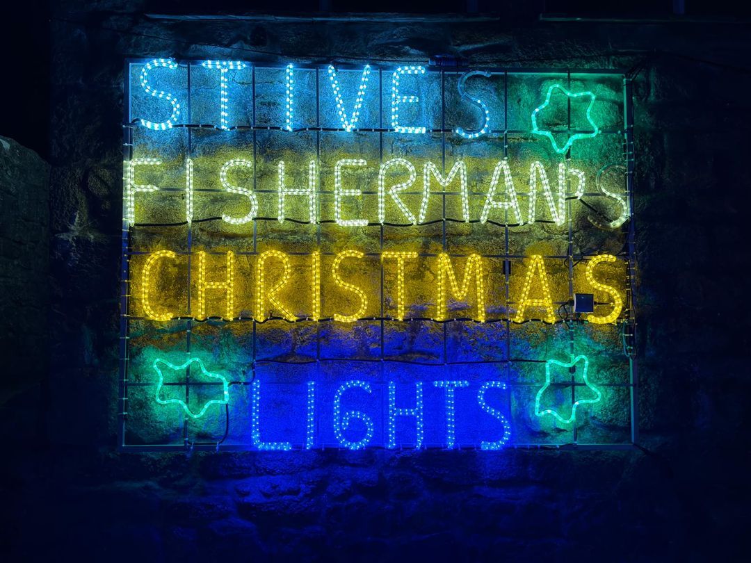 St Ives Fisherman's Christmas Lights illuminated sign on the harbourside