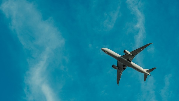 Airplane flying in a clear blue sky.