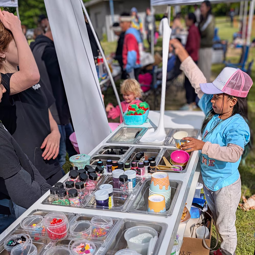 MooZoo CEO Luna-Belle enjoying hands-on slime making experience at Moo Zoo Slime Shop's portable slime bar in Grand Rapids