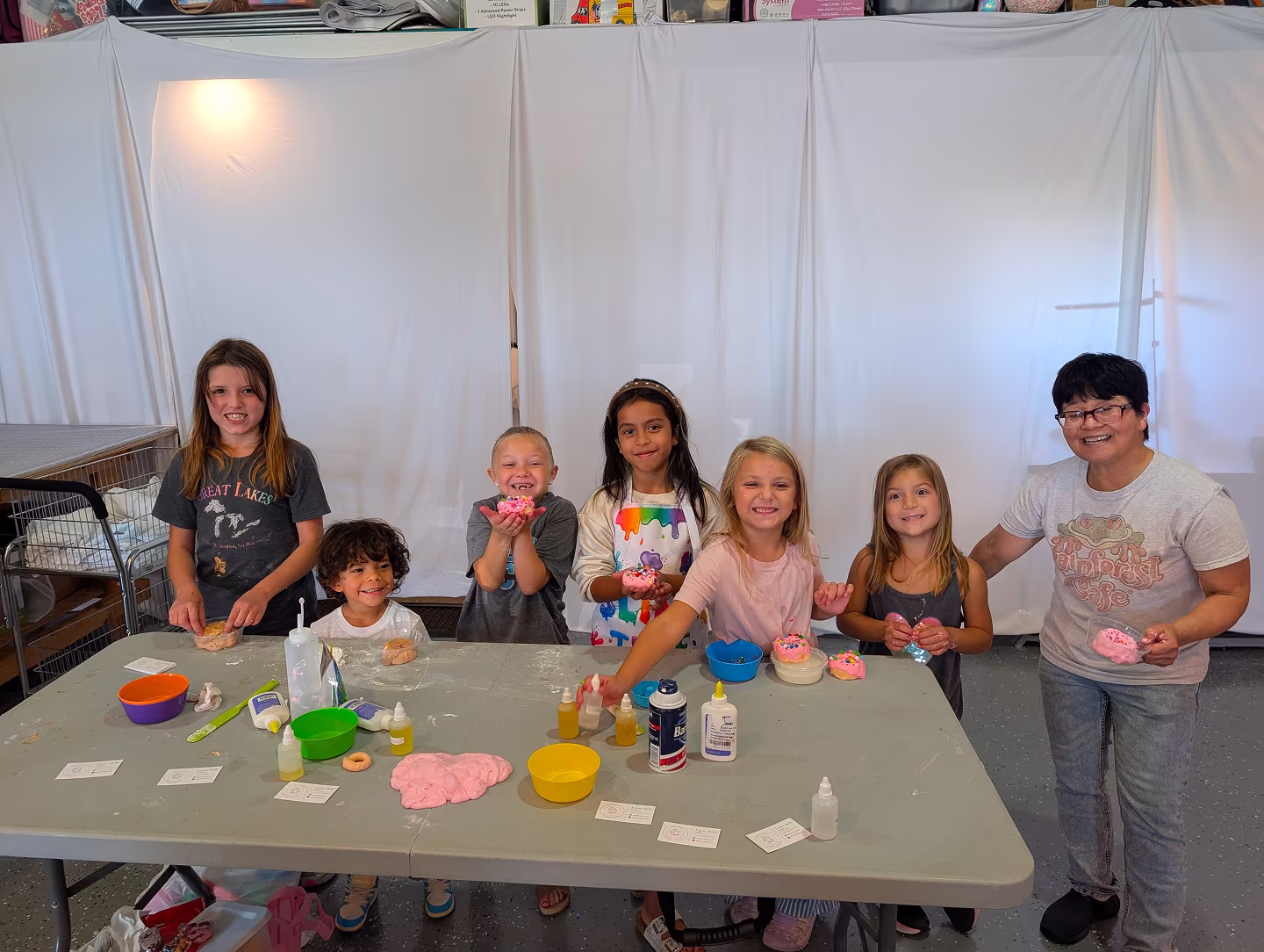 MooZoo CEO Luna-Belle and kids enjoying hands-on slime making workshop at Moo Zoo Slime Shop's portable slime bar in Grand Rapids