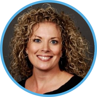 amie Gilmore's headshot. middle aged female with curly hair and friendly smile.