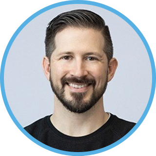 Topher Reynoso's headshot. male 30-40 years old with a beard and smiling.