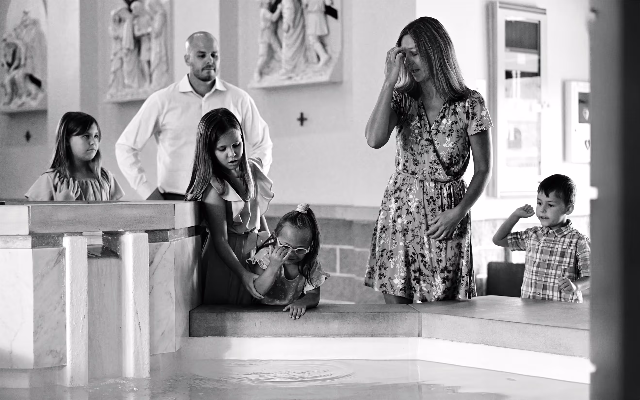 Catholic family making the Sign of the Cross