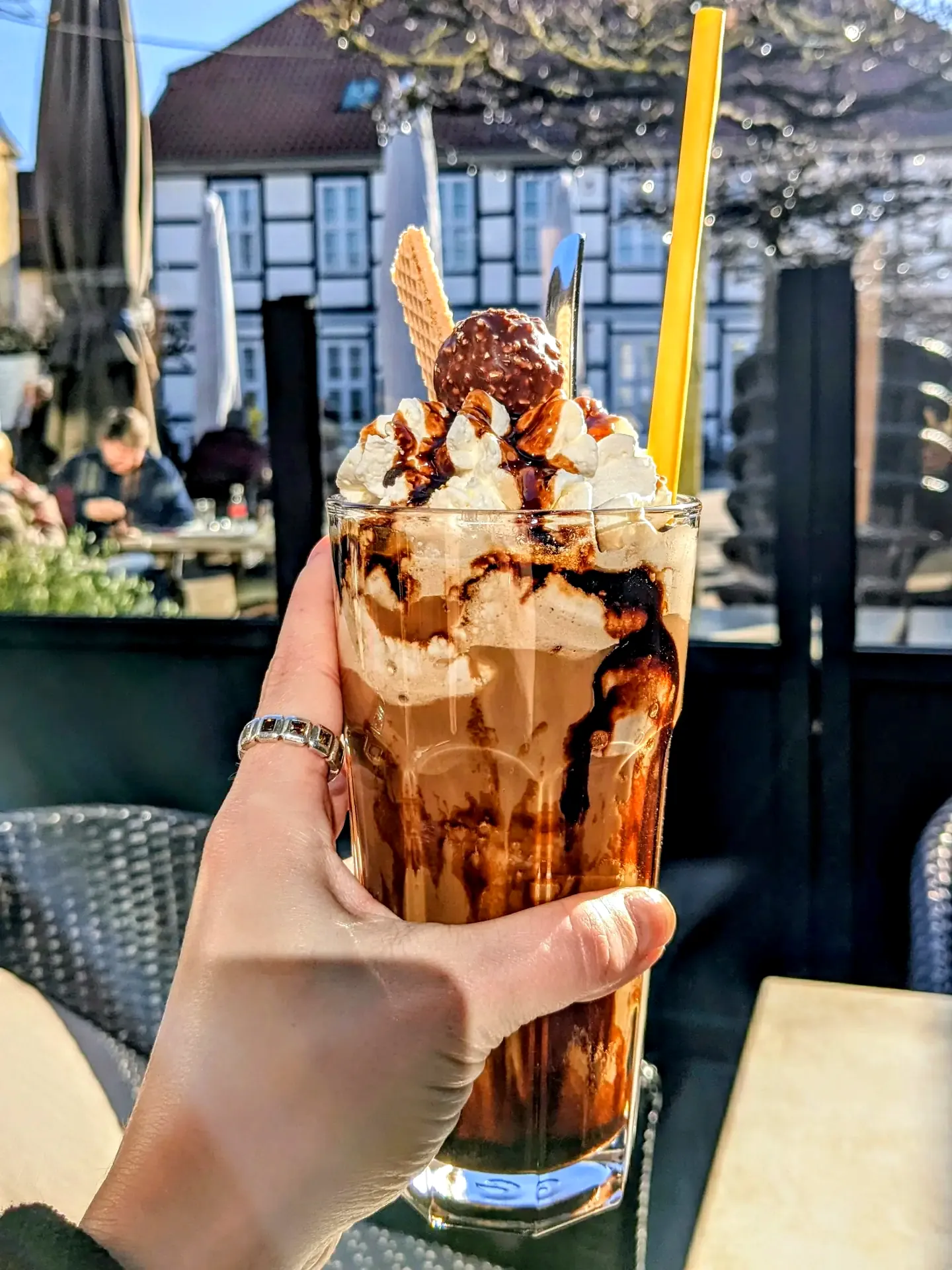 Eiskaffee auf der Terrasse vom Im Stadtgarten Uelzen mit Blick auf die Fachwerkhäuser in der Innenstadt