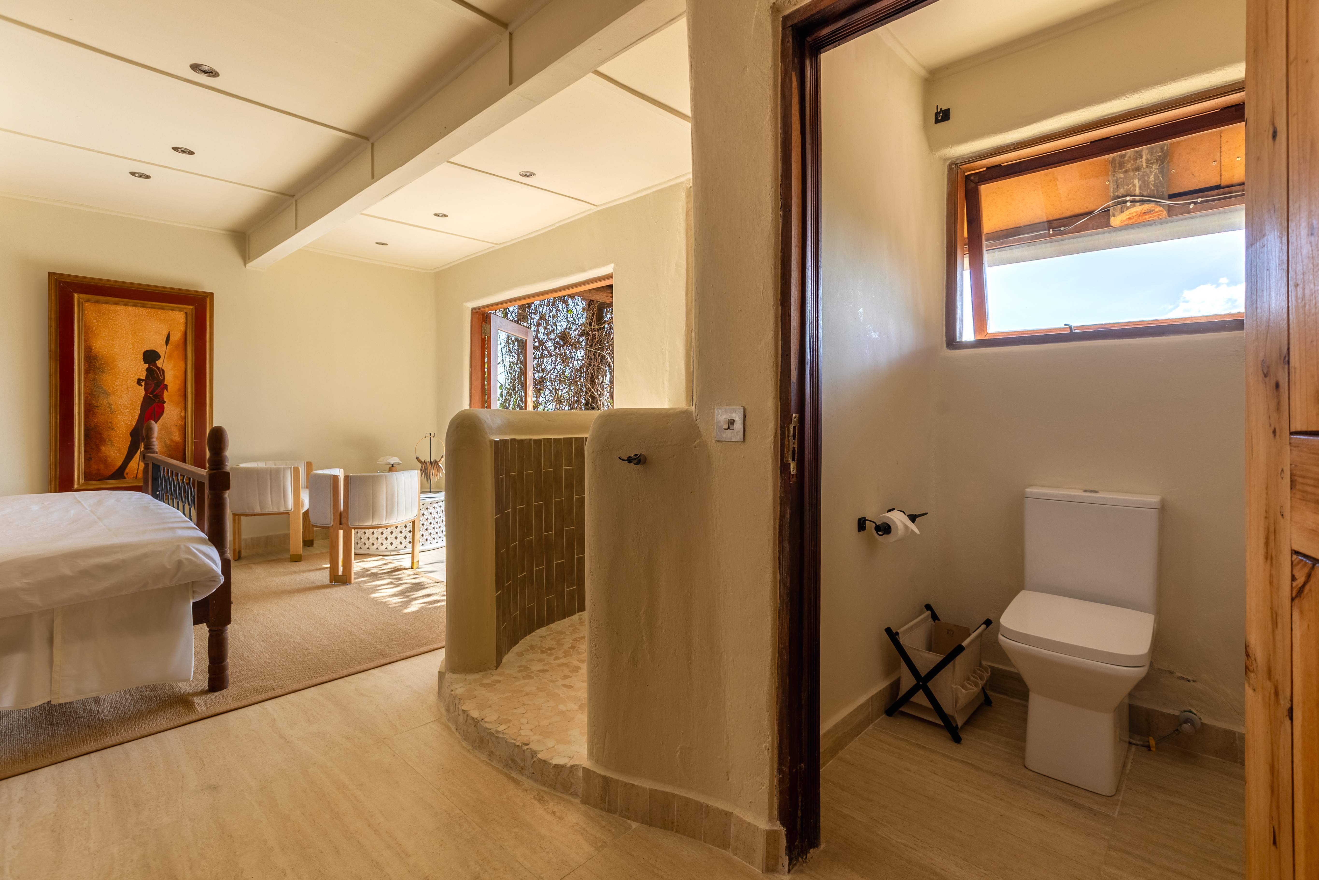 Balcony doors open to sweeping Mara views from the Cream Room.