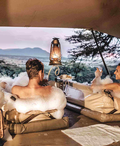 Open-air bath setup surrounded by wilderness views.