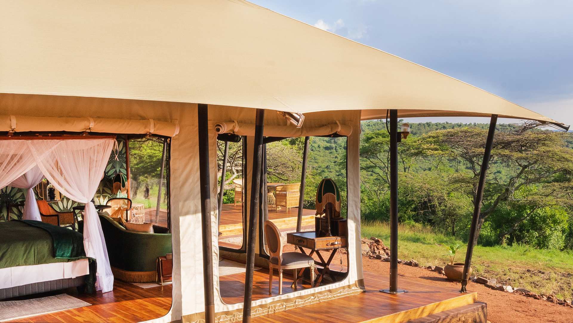 Duma Tent Exterior Exterior view of Duma Luxury Tent at Cottar’s 1920s Camp showing private deck and cream-toned canvas surrounded by the Mara landscape.