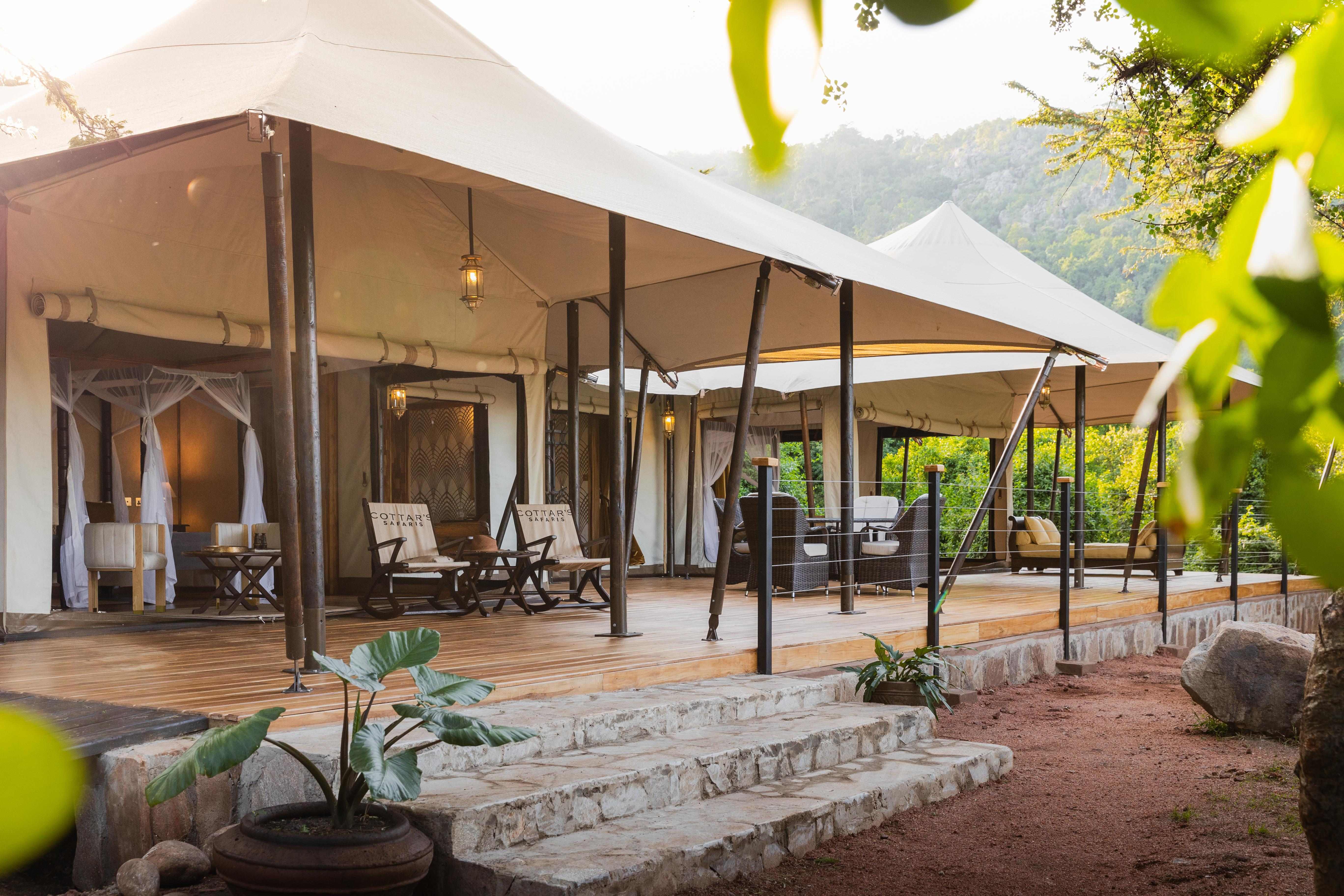 Sand Family Tent Interior Sand Family Tent at Cottar’s 1920s Camp featuring two en-suite bedrooms, lounge with wood stove, and deck with views of the Maasai Mara.