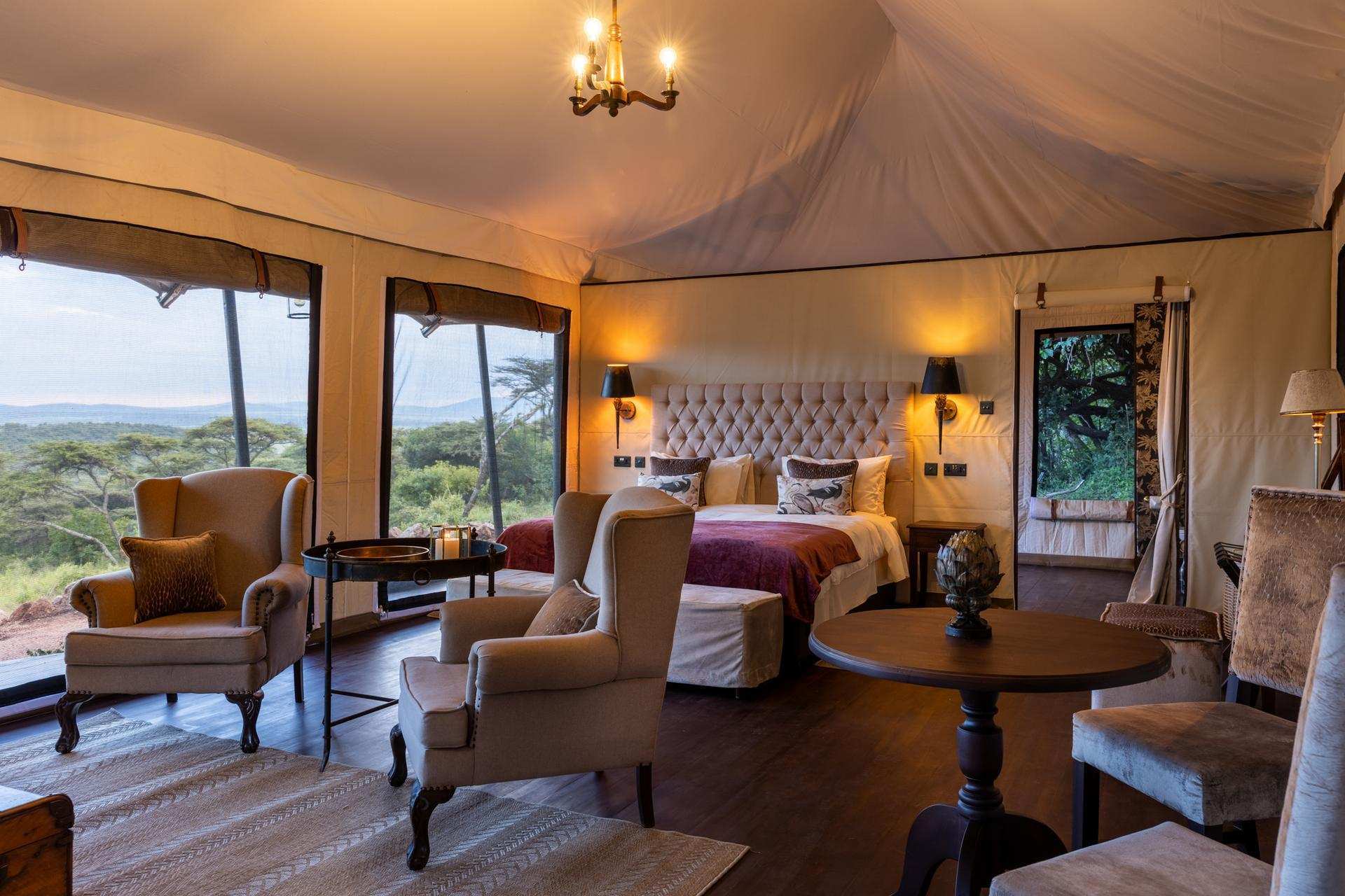 Athi Tent Interior Athi Luxury Tent at Cottar’s 1920s Camp with beige and cream interiors, antique decor, and private verandah overlooking the savannah.