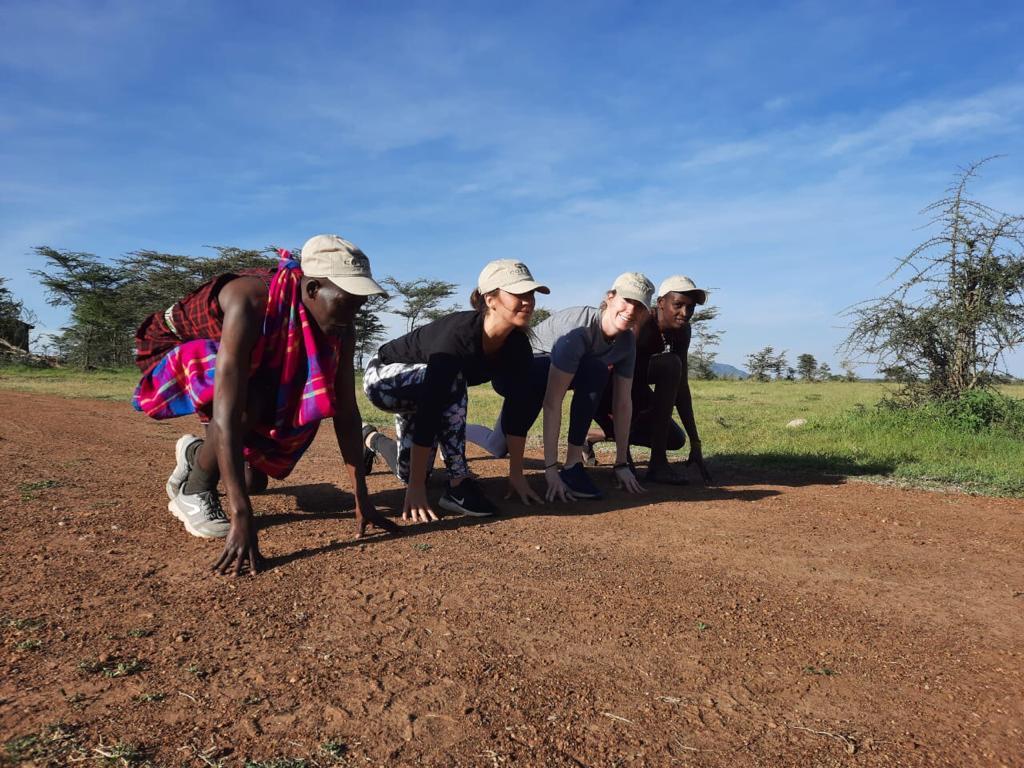 Guest jogging alongside a Maasai guide at sunrise.