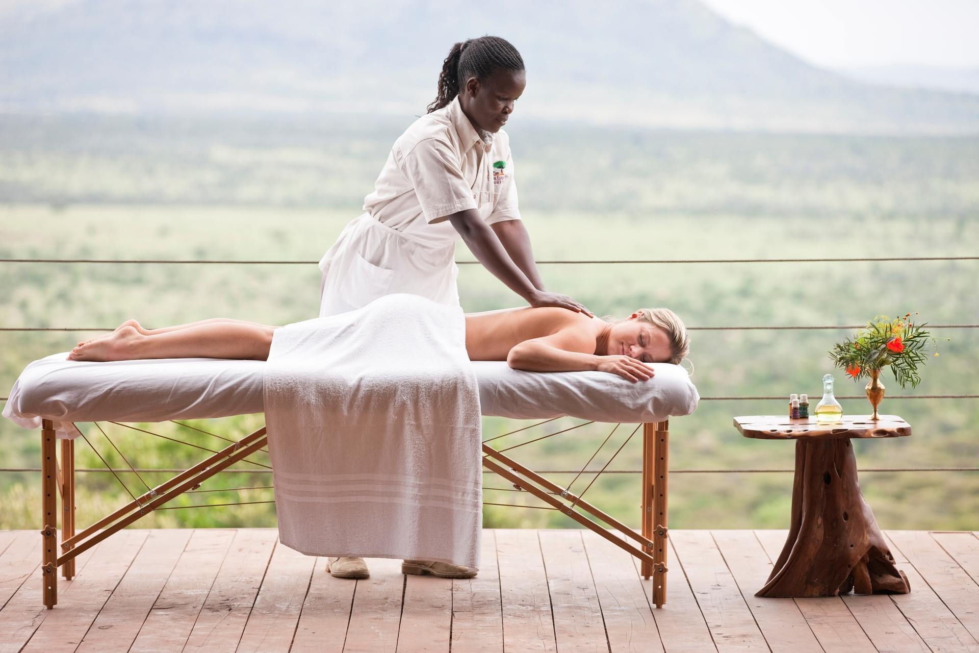 Massage therapist giving treatment inside the safari spa tent.