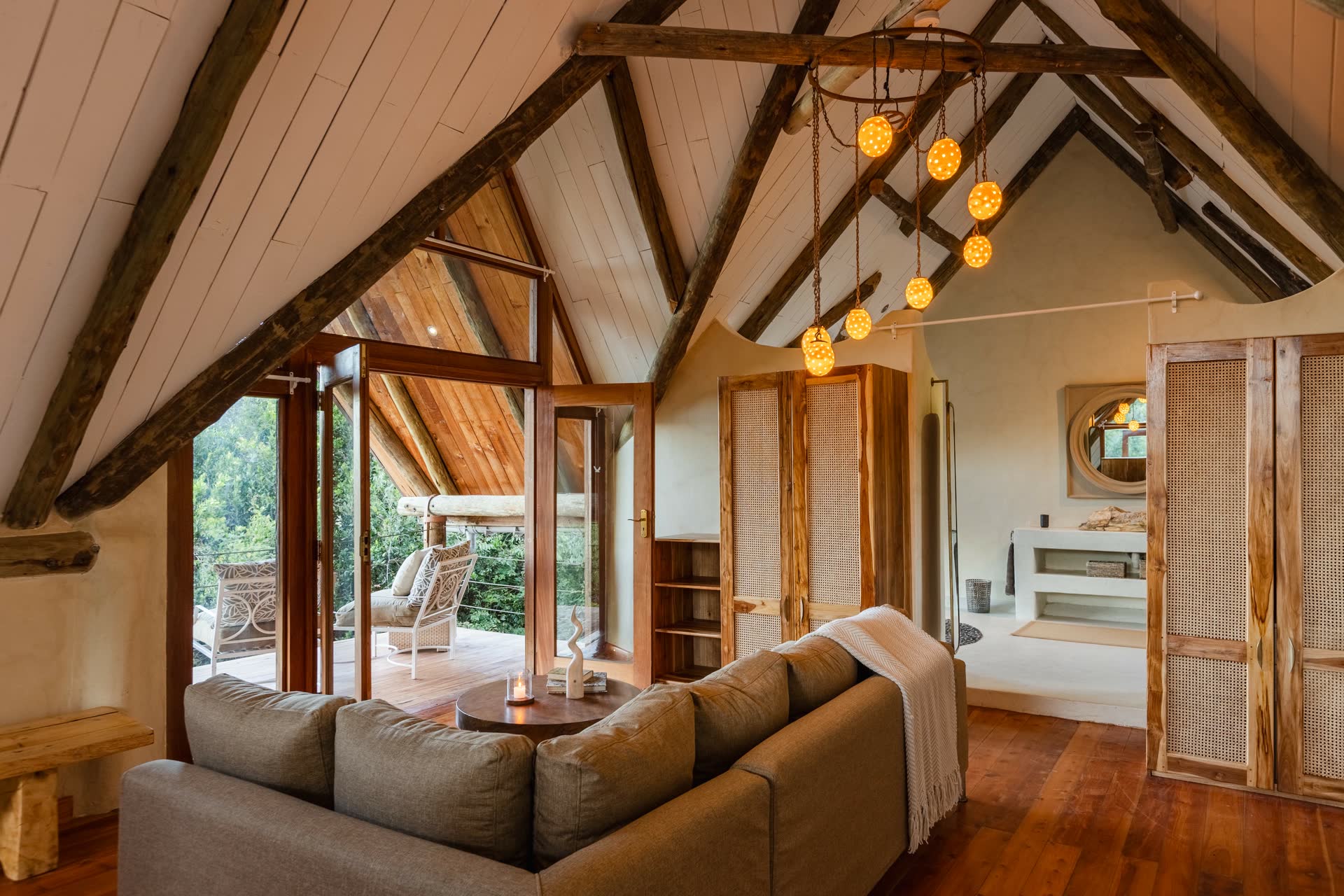 View toward the ensuite and dressing area with natural tones of green and cream.
