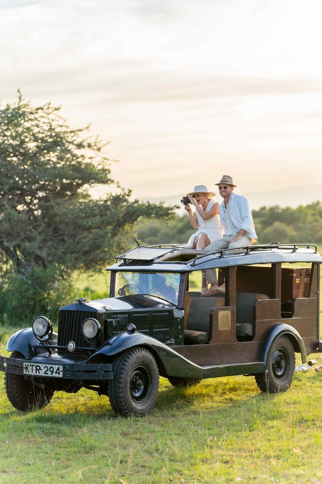 Guests on a private game drive across the Maasai Mara savannah with a safari guide.