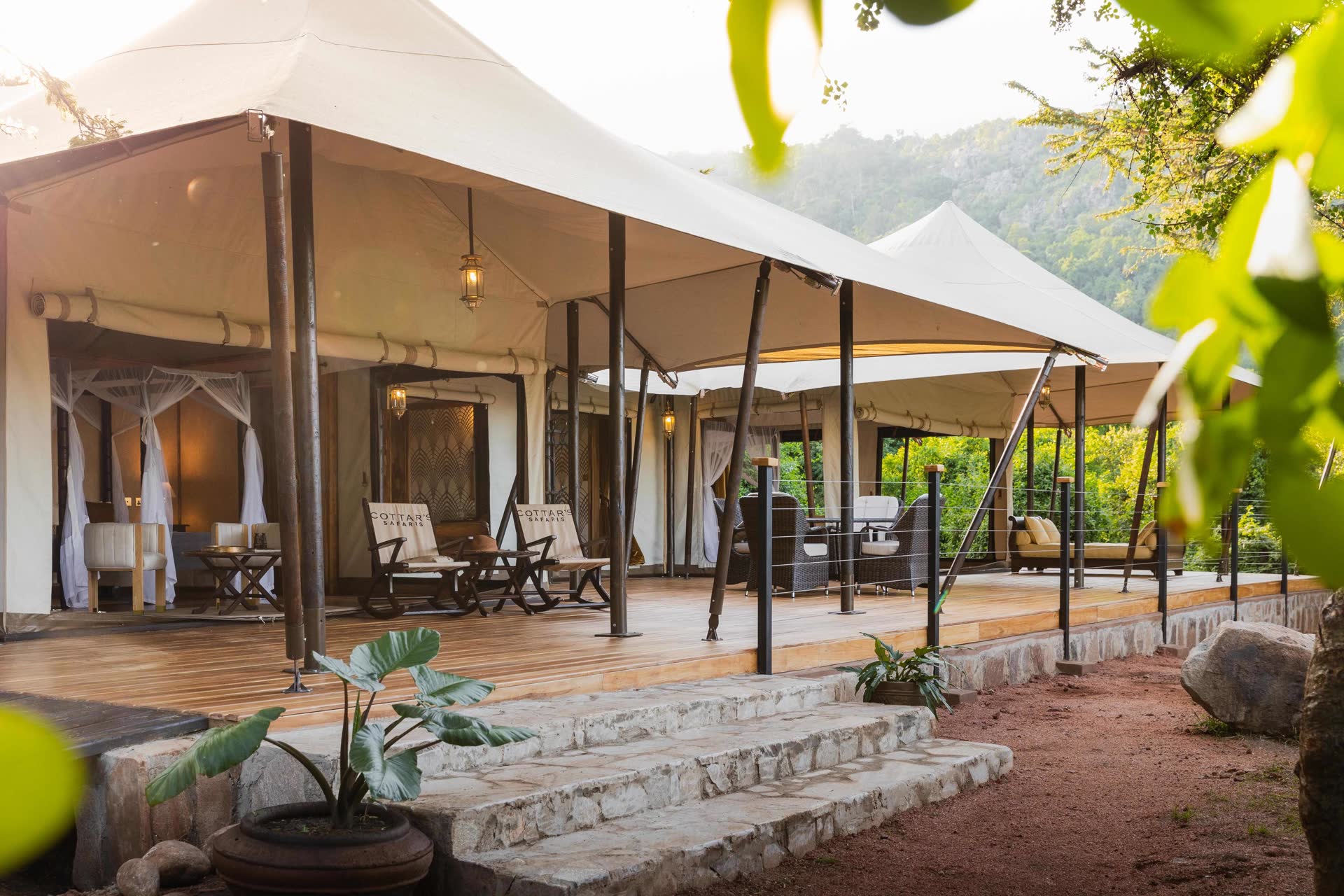 Sand Family Tent Interior Sand Family Tent at Cottar’s 1920s Camp featuring two en-suite bedrooms, lounge with wood stove, and deck with views of the Maasai Mara.