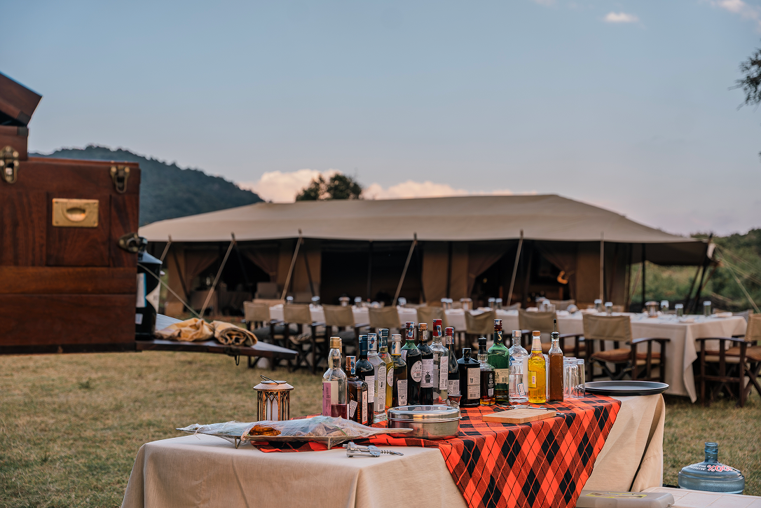 Bush dinner bar prepared for guests beneath the African sky at Cottar’s 1920s Camp.