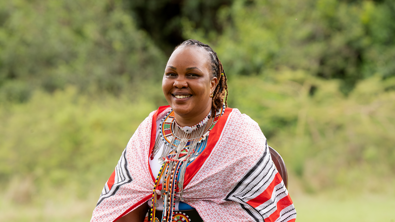 Portrait of Silver Guide Charity Lemein wearing traditional Maasai attire at Cottar’s 1920s Camp.