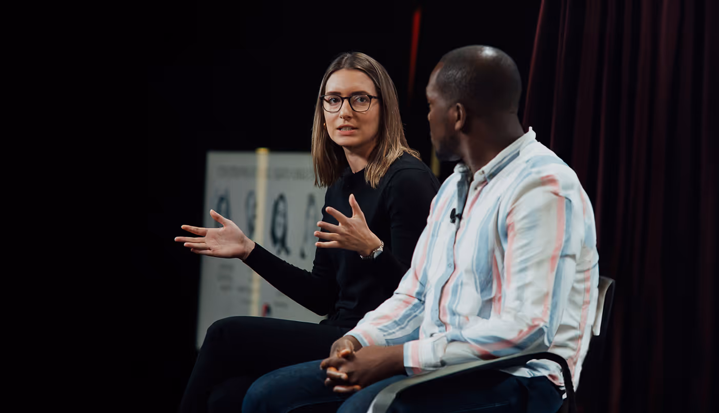 Woman-talking-to-man-on-antler-panel.