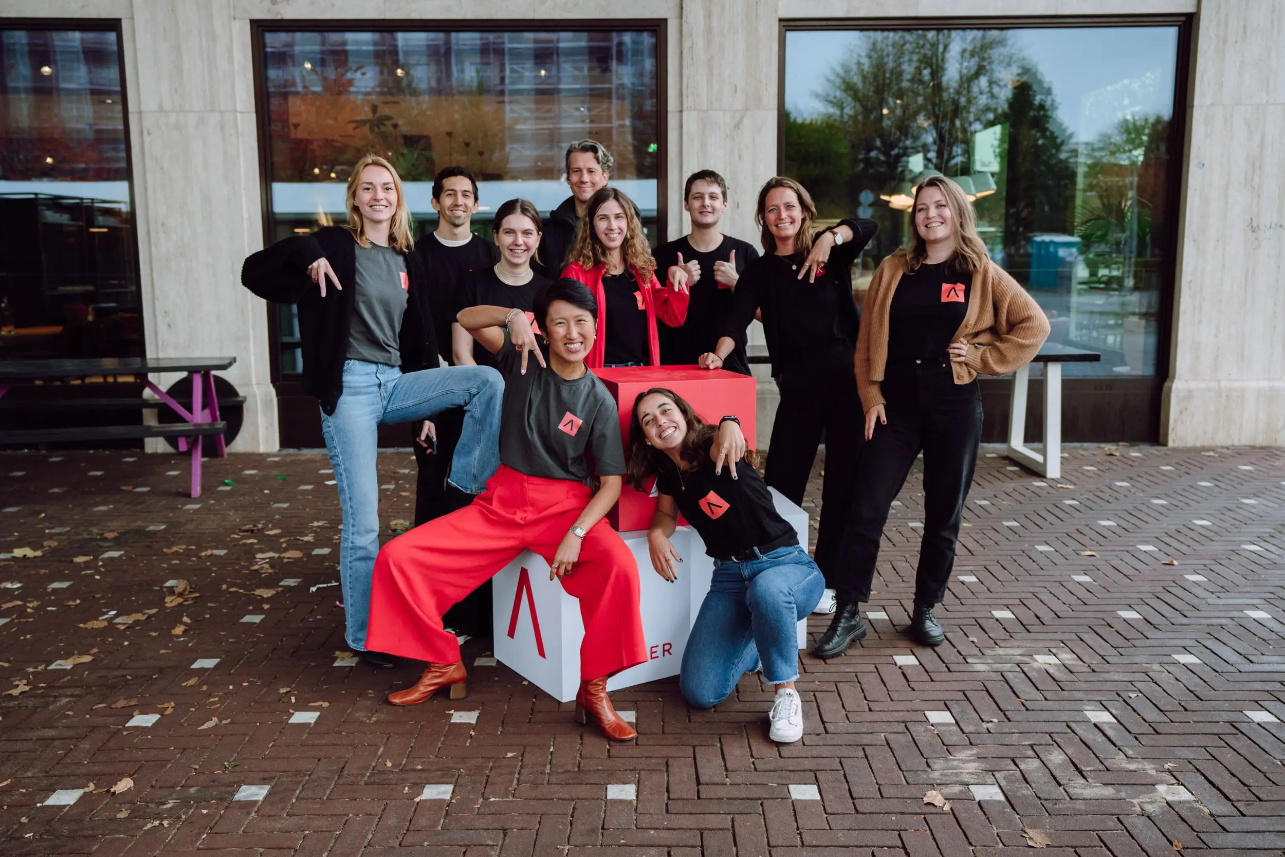 Antler team together outside an office building