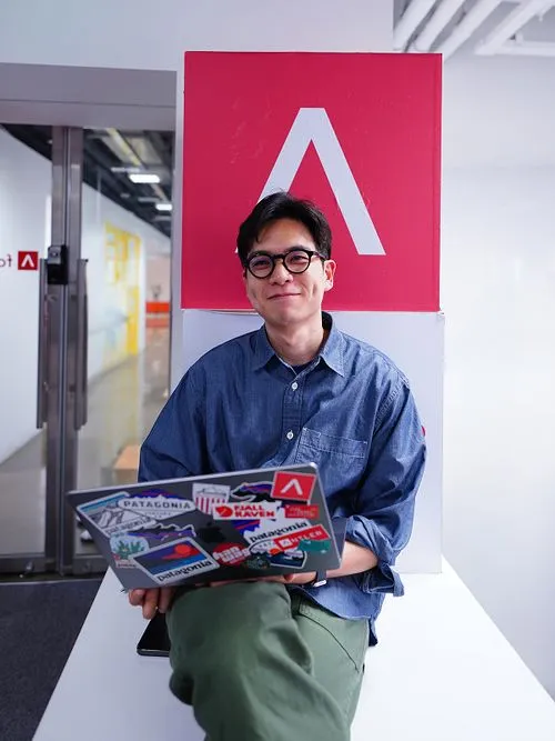 Antler founder sitting down with his laptop smiling