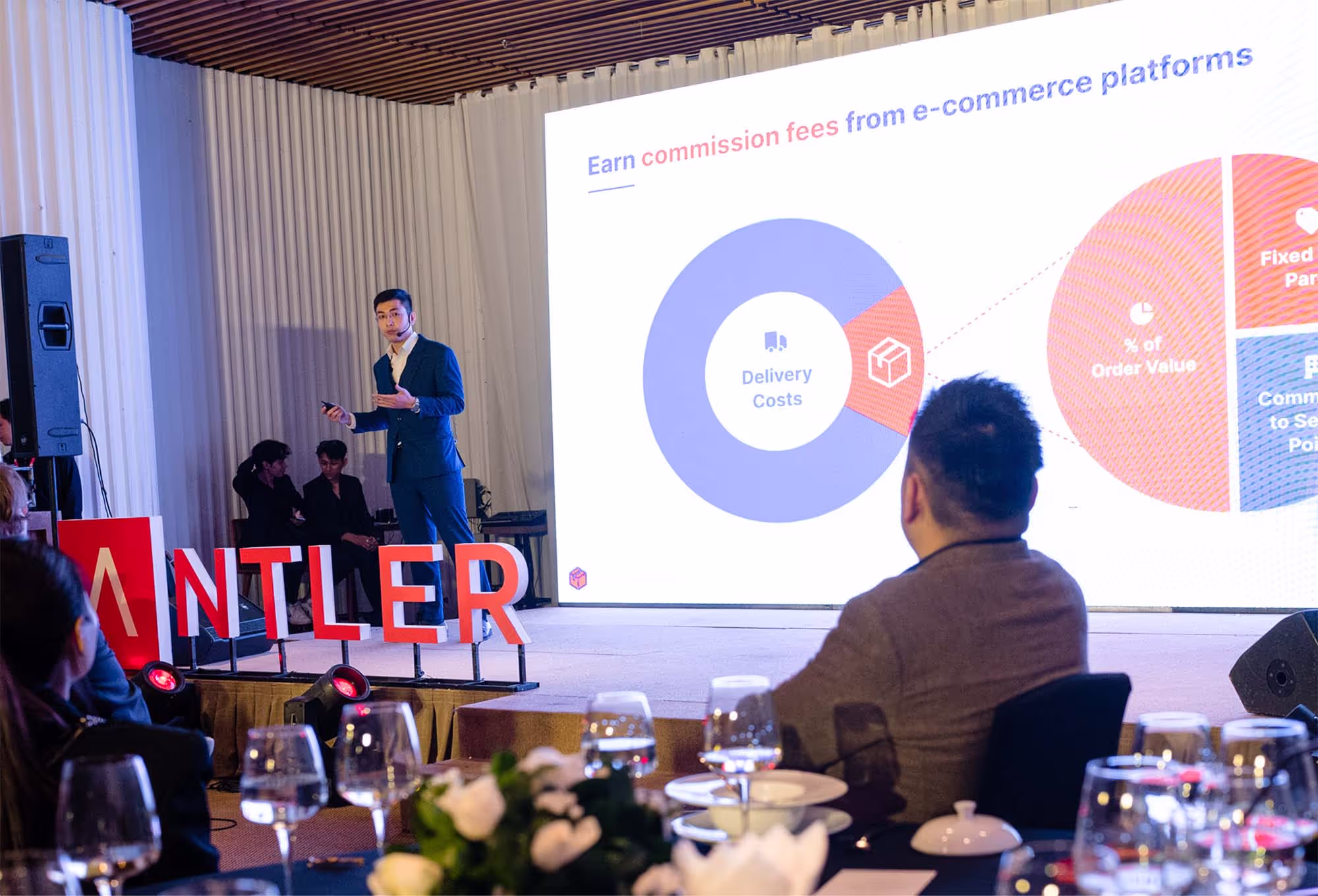 A large stage with Antler founder presenting