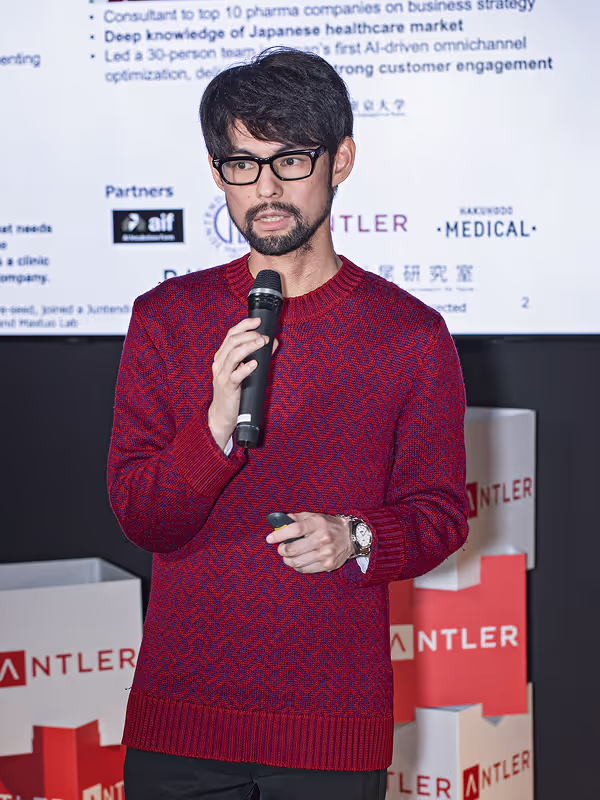 Antler founder pitching in red sweater