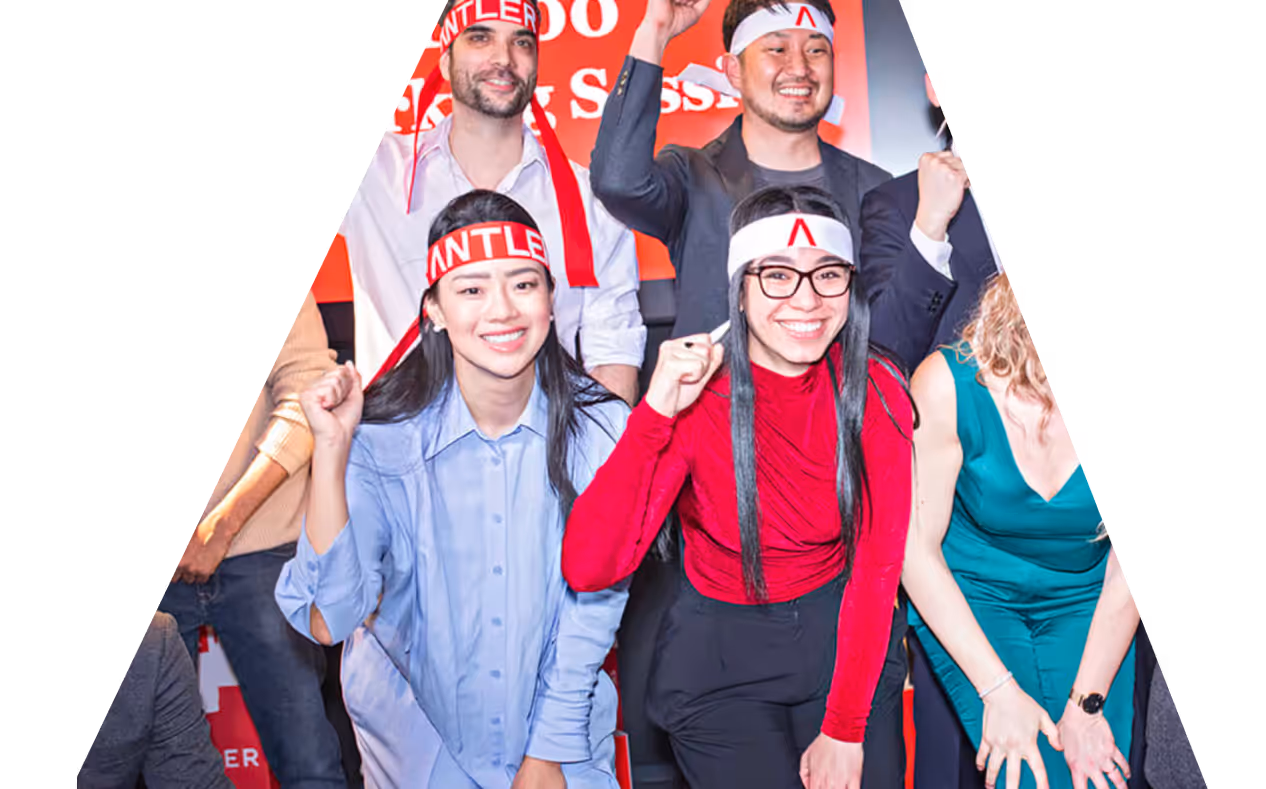 A group of people wearing headbands and holding up their hands.