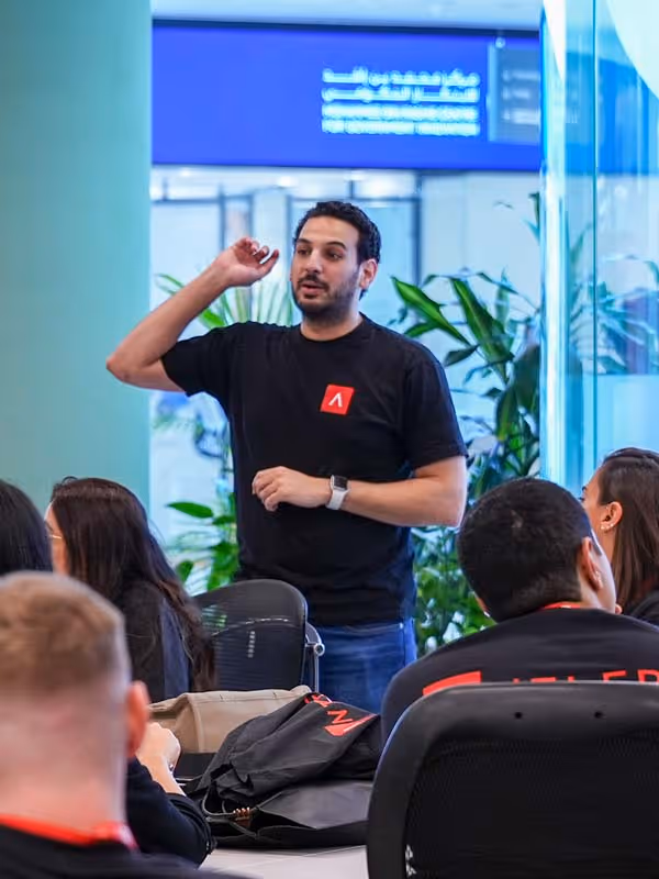 A man wearing a black shirt with an A on it.