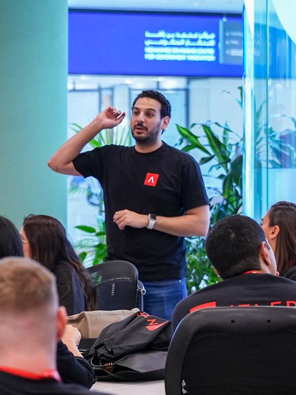 A man wearing a black shirt with an A on it.