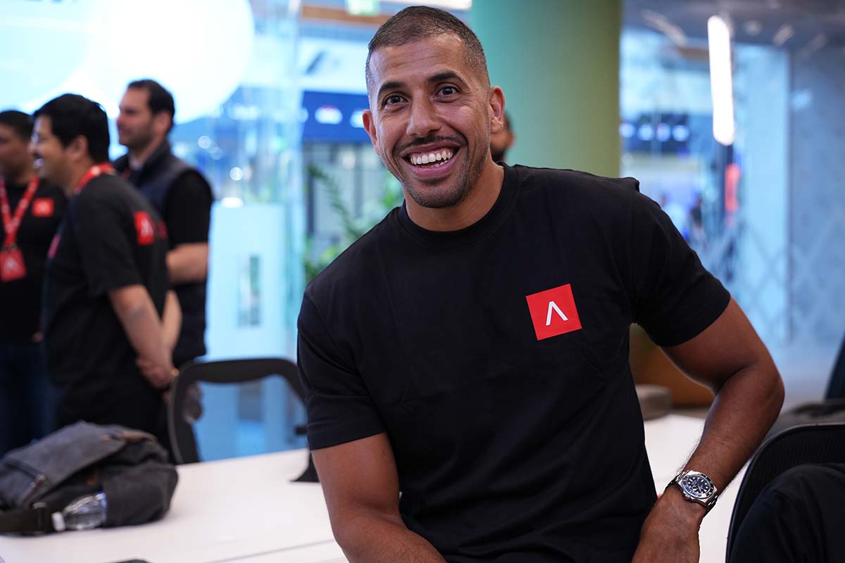 A man wearing a black shirt with an A on it.