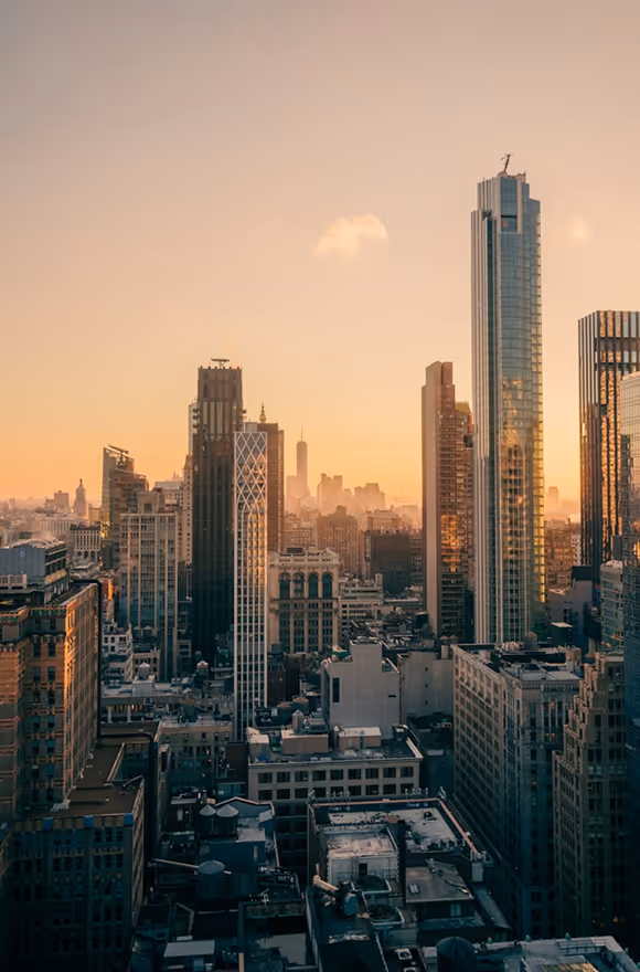 A view of a city skyline at sunset.