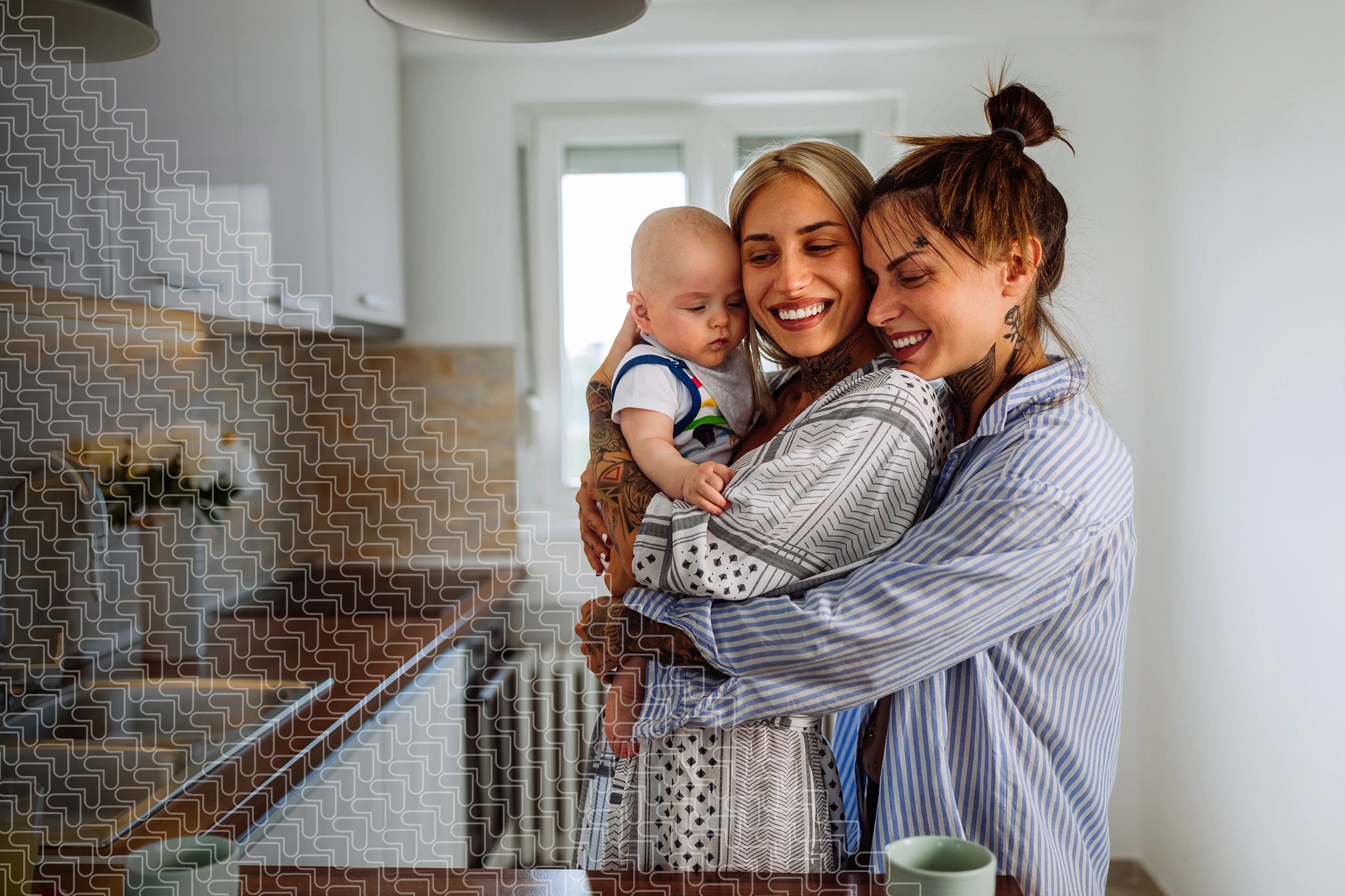 young couple in kitchen hugging with baby 
