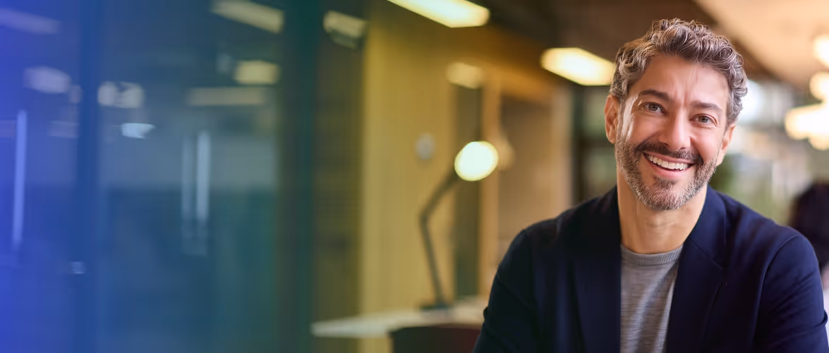 Business professional smiling in a modern office setting for Impossible Cloud 5TB storage campaign